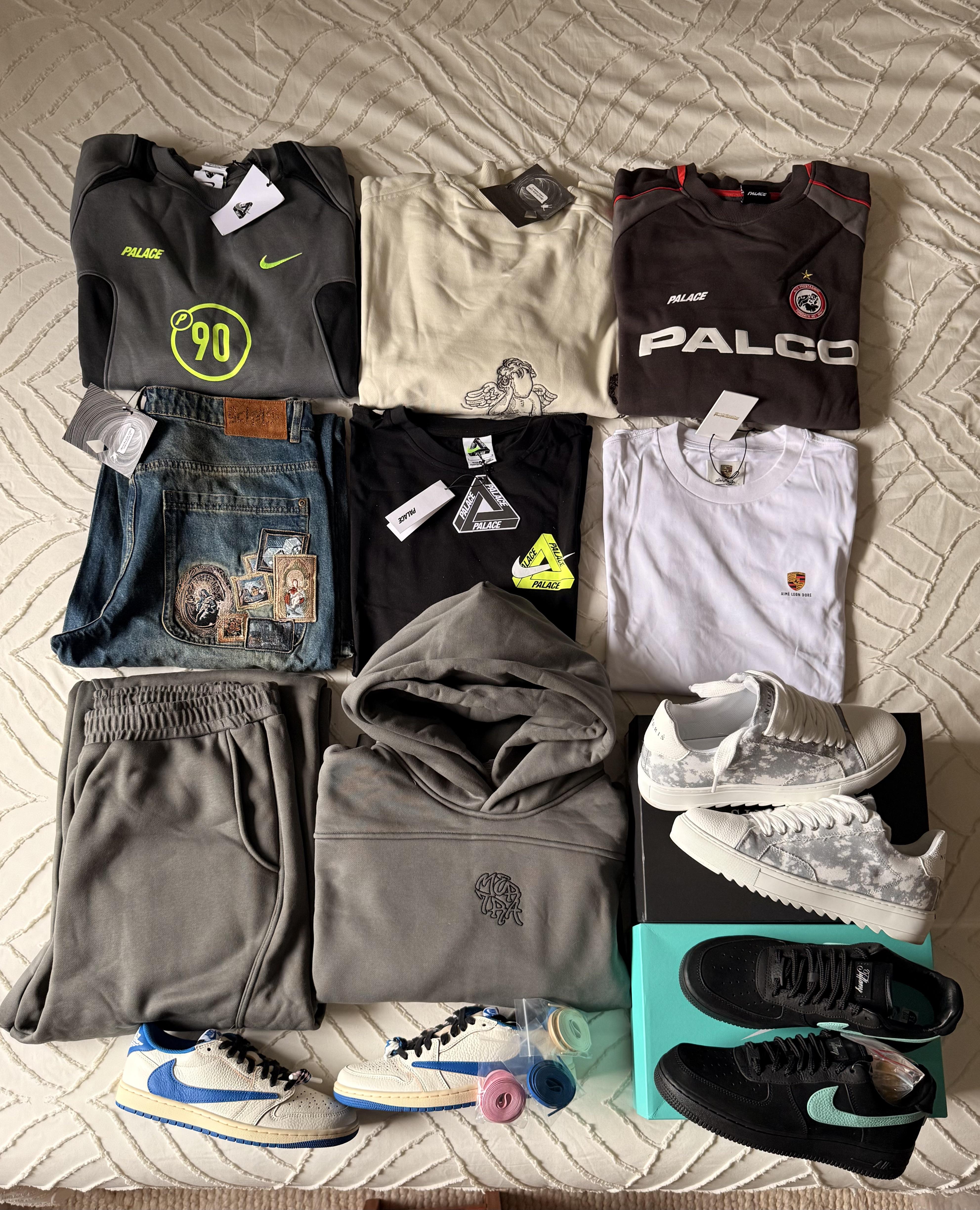 Clothes and sneakers arranged on a bed in the original Brazil haul post